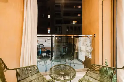 a balcony with two chairs and a window at NEW Apartment Central 1BR-Queensize, AC&Terrace in Marrakech
