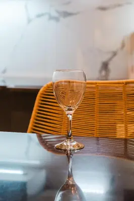 a wine glass sitting on top of a table at NEW Apartment Central 1BR-Queensize, AC&Terrace in Marrakech