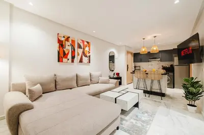 a living room with a couch and a kitchen at NEW Apartment Central 1BR-Queensize, AC&Terrace in Marrakech