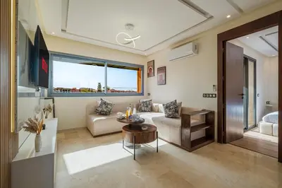 a living room with a couch and a table at NEW Apartment 1BR Kingsize, AC & Terrace in Marrakech