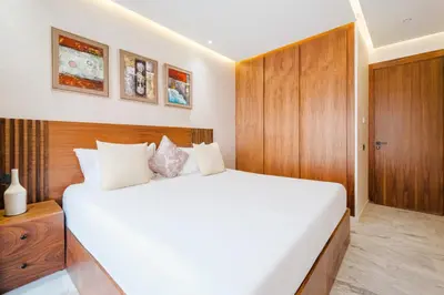 a bedroom with a large white bed and wooden cabinets at Modern Comfort in Heart of Marrakech in Marrakech