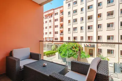 a balcony with a table and chairs and a building at Modern Comfort in Heart of Marrakech in Marrakech