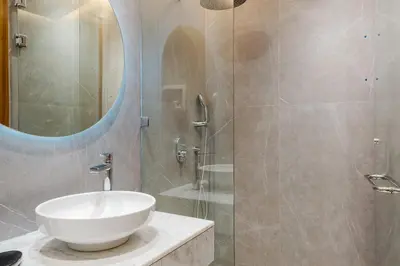a bathroom with a sink and a glass shower at Modern Comfort in Heart of Marrakech in Marrakech