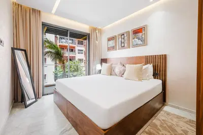 a bedroom with a large white bed and a window at Modern Comfort in Heart of Marrakech in Marrakech