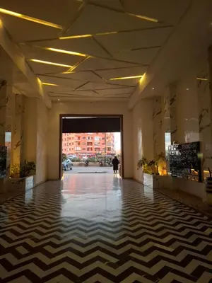 a lobby with a checkered floor in a building at Burj malak in Marrakech