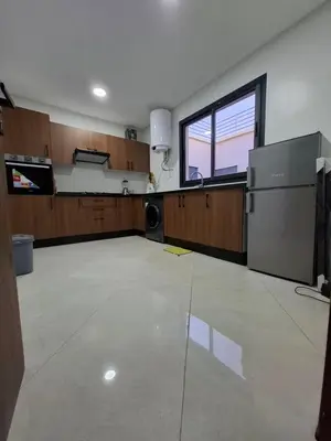 an empty room with a kitchen and a large window at Burj malak in Marrakech