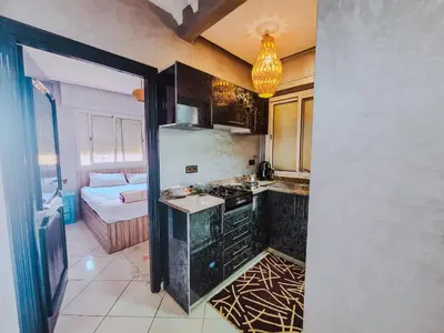 a kitchen with a refrigerator and a stove top oven at NARJI HOTEL Guéliz in Marrakech