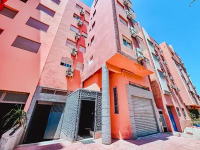 an orange building with a door in front of it at NARJI HOTEL Guéliz in Marrakech