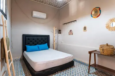 a small bedroom with a bed and a bath tub at Cozy studio with private terrace in Marrakech