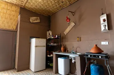 a kitchen with a refrigerator and a stove at Cozy studio with private terrace in Marrakech