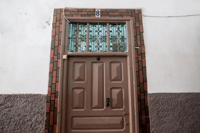 a brown door with a window on a building at Cozy studio with private terrace in Marrakech