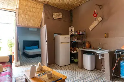 a kitchen with a refrigerator and a table at Cozy studio with private terrace in Marrakech