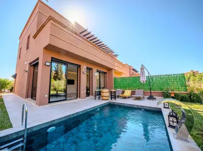 a swimming pool in front of a house at Villa Smahane - Comfort & Private Pool in Marrakech
