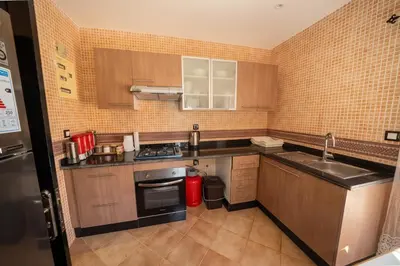 a kitchen with a sink and a stove at Villa Smahane - Comfort & Private Pool in Marrakech