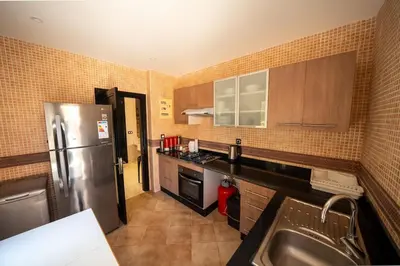 a kitchen with a stainless steel refrigerator and a sink at Villa Smahane - Comfort & Private Pool in Marrakech