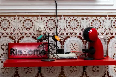 a red shelf with a red object on a wall at Authentic Moroccan Stay Steps from Jemaa el-Fna in Marrakech