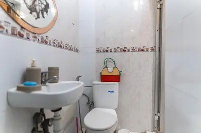 a bathroom with a toilet and a sink at Authentic Moroccan Stay Steps from Jemaa el-Fna in Marrakech