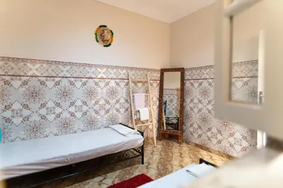 a room with a bed and a mirror at Authentic Moroccan Stay Steps from Jemaa el-Fna in Marrakech