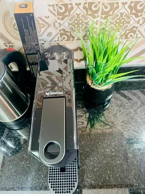 a cell phone sitting on a counter next to a plant at Modern apartment with pool & gym in Marrakech