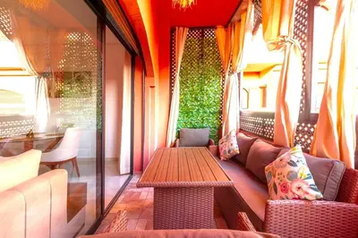 a room with a table and a couch and a table sidx sidx at Modern apartment with pool & gym in Marrakech