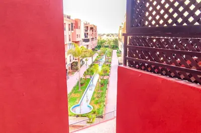 a view of a street from a red building at Modern apartment with pool & gym in Marrakech