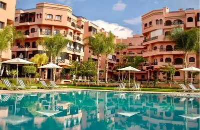 a swimming pool in front of a building at Modern apartment with pool & gym in Marrakech