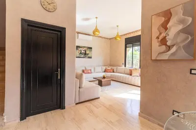 a living room with a black door and a couch at Luxury private villa with heated pool in Marrakech