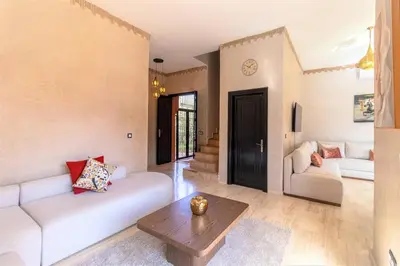 a living room with a white couch and a table at Luxury private villa with heated pool in Marrakech