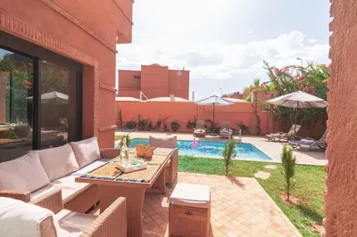 a patio with a table and chairs and a pool at Luxury private villa with heated pool in Marrakech