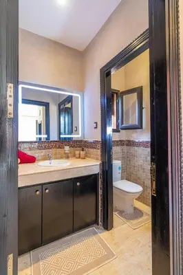 a bathroom with a sink and a toilet at Luxury private villa with heated pool in Marrakech