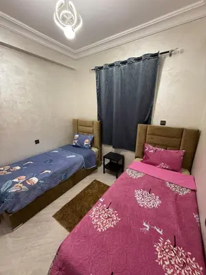 a bedroom with two beds and a window at Moroccan elegance Quiet & Comfort 5min airport in Marrakech