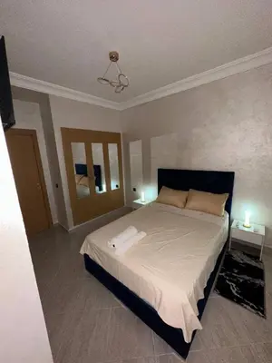 a bedroom with a large bed with two night stands at Moroccan elegance Quiet & Comfort 5min airport in Marrakech