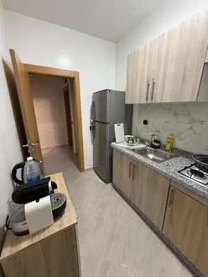 a kitchen with a sink and a refrigerator at Moroccan elegance Quiet & Comfort 5min airport in Marrakech