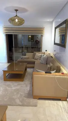 a living room with a couch and a table at 3 bedroom apartment prestigia jade in Marrakech
