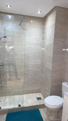 a bathroom with a toilet and a glass shower at 3 bedroom apartment prestigia jade in Marrakech