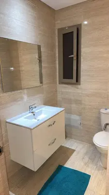 a bathroom with a sink and a toilet and a mirror at 3 bedroom apartment prestigia jade in Marrakech