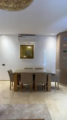 a dining room with a table and chairs at 3 bedroom apartment prestigia jade in Marrakech