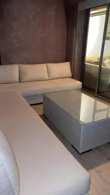 a living room with a couch and a glass table at 3 bedroom apartment prestigia jade in Marrakech