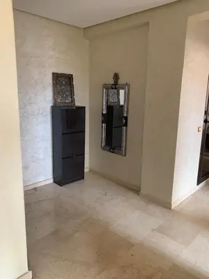 an empty room with a black cabinet and a mirror at Modern appartement in Marrakech in Marrakech
