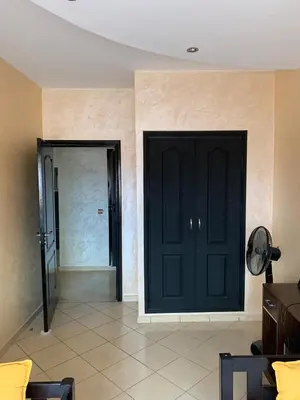 a room with two black doors and a tile floor at Modern appartement in Marrakech in Marrakech