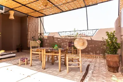 a patio with a table and chairs on a patio at Apartment with panoramic views of Koutoubia in Marrakech
