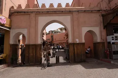 an archway in a building with a person on a bike at Apartment with panoramic views of Koutoubia in Marrakech
