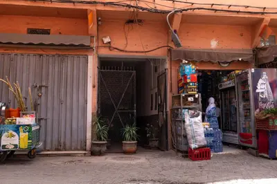 an entrance to a store with a woman standing outside at Apartment with panoramic views of Koutoubia in Marrakech