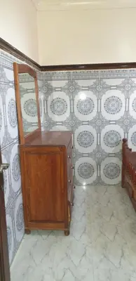 a room with a wooden cabinet and a tiled wall at Chez Omar in Marrakech
