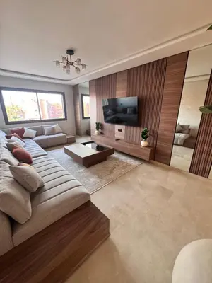 a living room with a couch and a flat screen tv at Le pavillon gueliz appartement de luxe in Marrakech