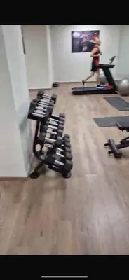 a woman running in a gym with rows of exercise equipment at Le pavillon gueliz appartement de luxe in Marrakech
