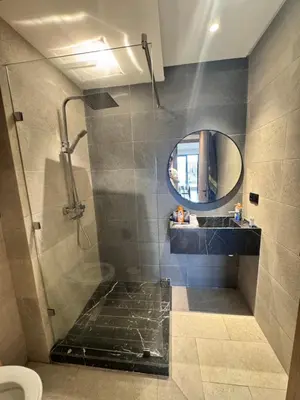 a bathroom with a shower and a mirror at Le pavillon gueliz appartement de luxe in Marrakech