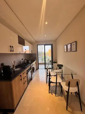 a kitchen and dining room with a table and chairs at Le pavillon gueliz appartement de luxe in Marrakech