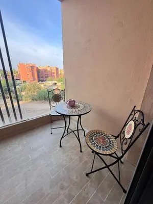 a balcony with a table and chairs and a window at Le pavillon gueliz appartement de luxe in Marrakech