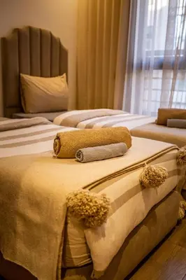three beds are lined up in a room at Magnifique appartement 2 chambres à Menara Garden Marrakech in Marrakech